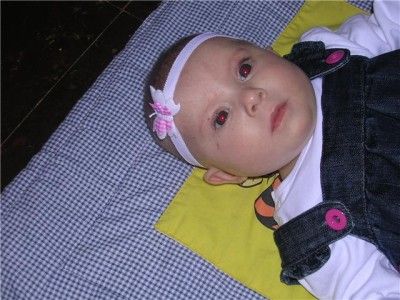 Below Baby Isabelle aged 16 weeks wearing her pink and white butterfly 